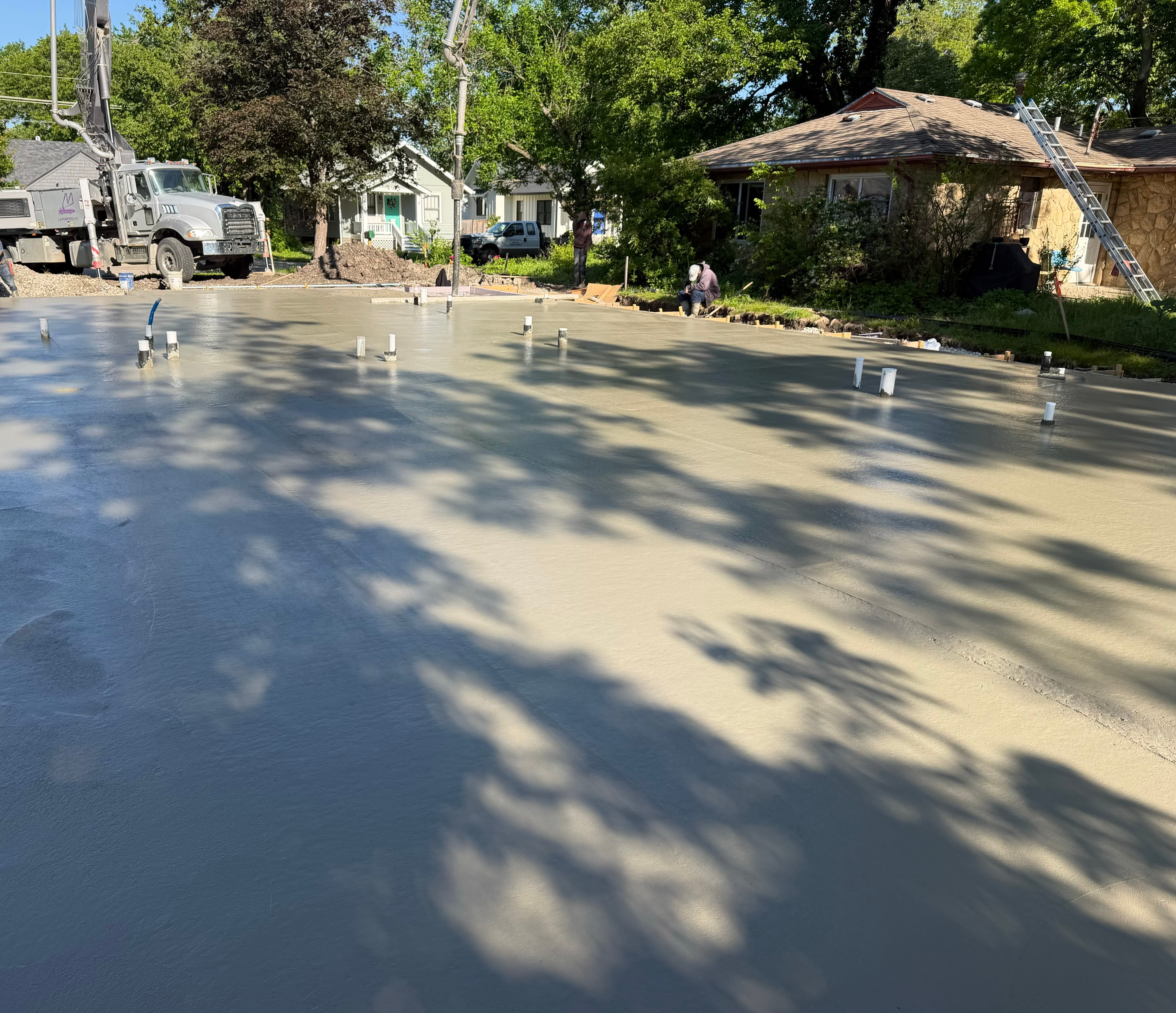 Fresh concrete slab poured and being finished at the HFS build site